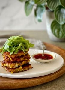 This Corn Zucchini Carrot Fritters recipe is a stack of plant powered goodness is a quick and easy to make light meal or snack.