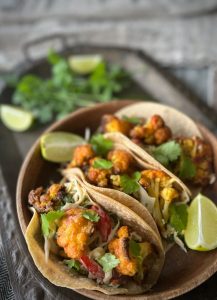 These Cauliflower Tacos are a really simple, easy to make vegetarian meal. The slaw is a lovely fresh accompaniment to the baked cauliflower, all wrapped in a convenient tortilla or taco.