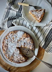 Gluten-free Italian almond cake topped with powdered sugar—a moist, nutty, and elegant dessert.