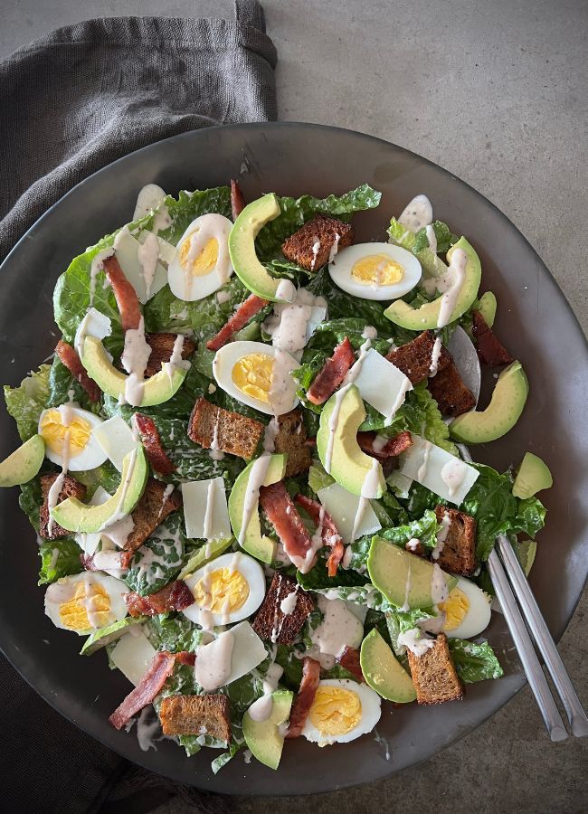 This classic Caesar salad features crispy bacon, crunchy croutons, and a creamy homemade dressing. A versatile and delicious meal or side!