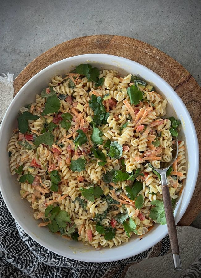This curried pasta salad combines pasta, fresh veggies & a creamy curry dressing for a delicious, easy side. Perfect with protein or as is!