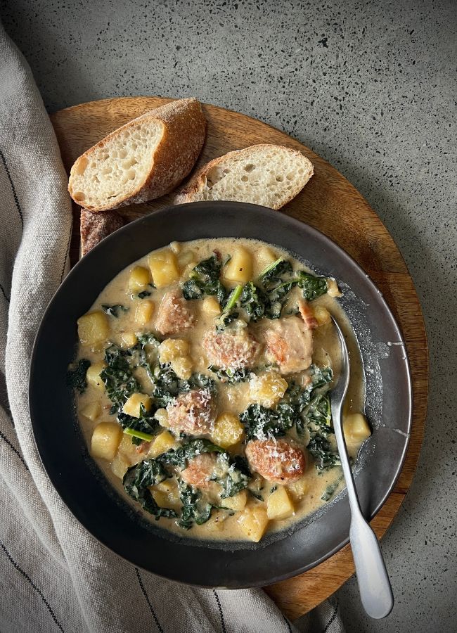 This creamy Toscano Soup is a nourishing one-pot wonder made with sausage, potato, kale, and a hint of spice. Dairy-free option included.