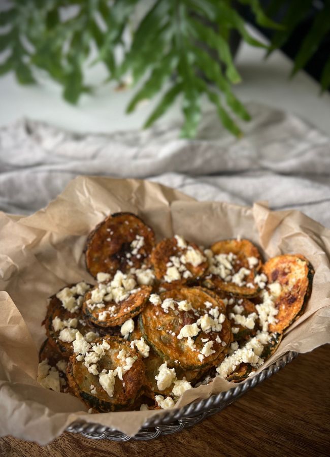 These crispy baked Greek Zucchini Chips are a delicious, healthier alternative to regular fries - great for snacking or serving as a side.