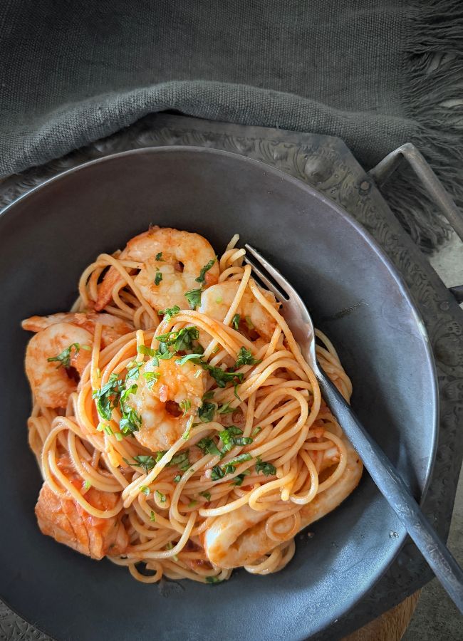 A quick and super simple seafood spaghetti marinara. It's high in protein, family-friendly and ready in under 30 minutes.