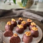 Chocolate brownie protein balls with 10 g protein each. A rich, no-bake whole food snack coated in dark chocolate, perfect for healthy treats.